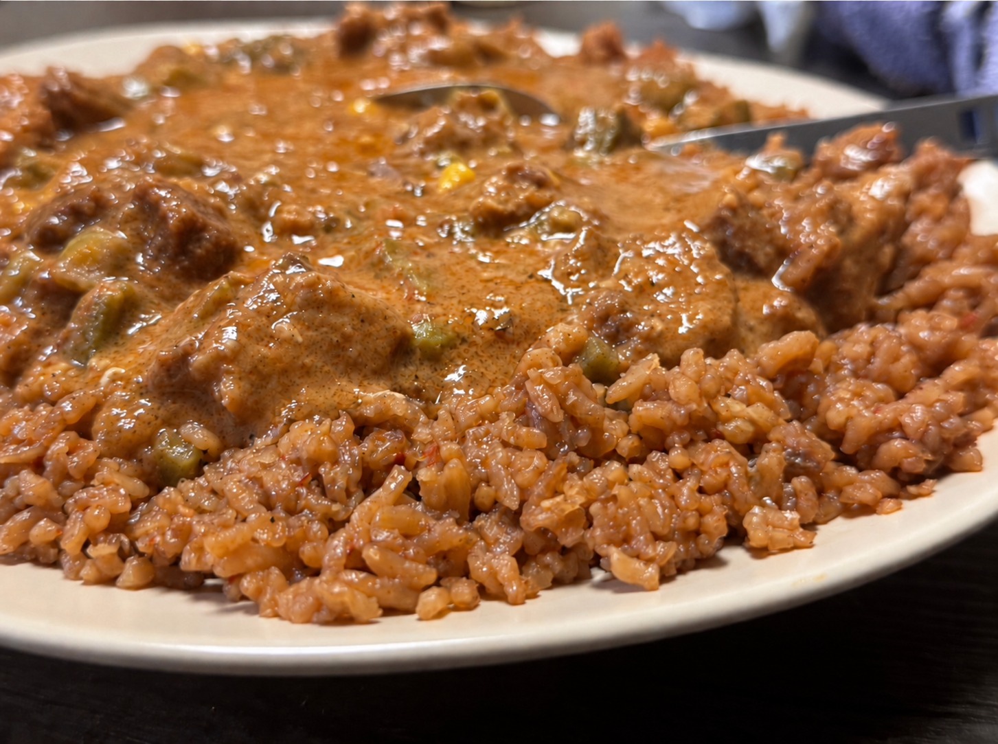 Beef Peanut Butter Stew served over rice on a plate