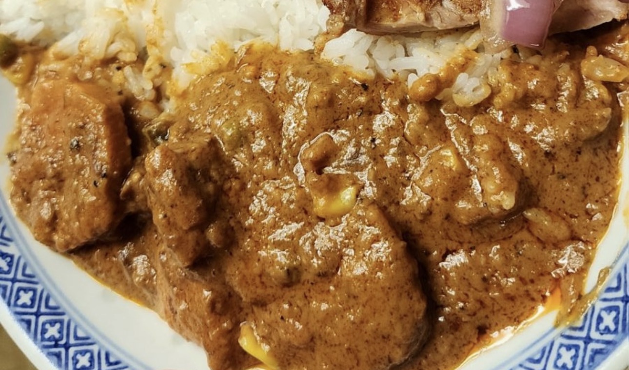 Beef Peanut Butter Stew with sweet potatoes and rice in a patterned bowl