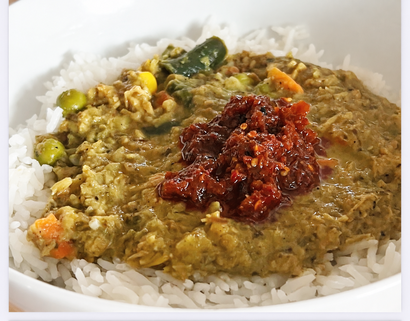 Jumpin’ Green Chicken Curry served over rice with optional Nopsauce on top