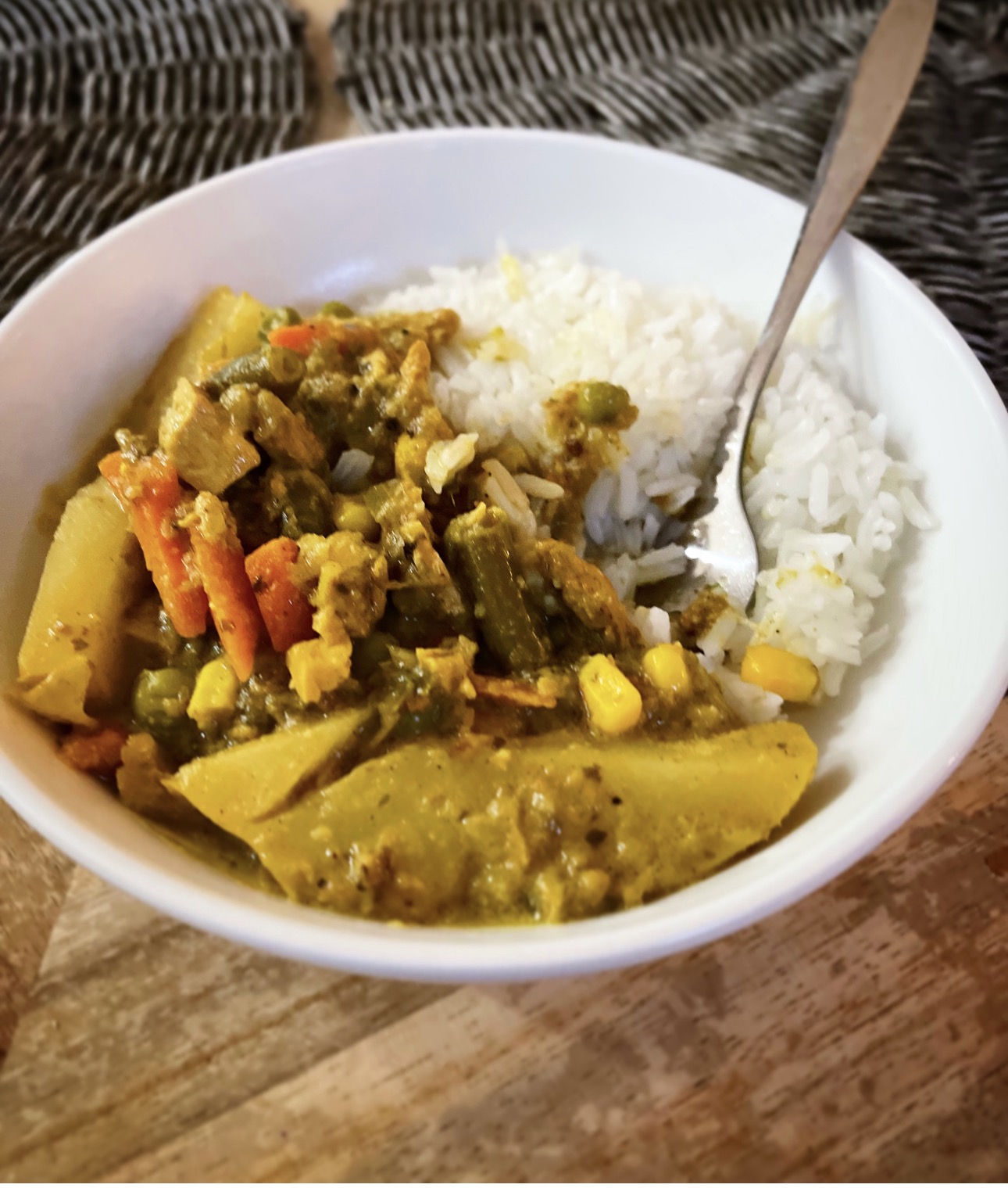 Jumpin’ Green Chicken Curry with vegetables and rice in a white bowl